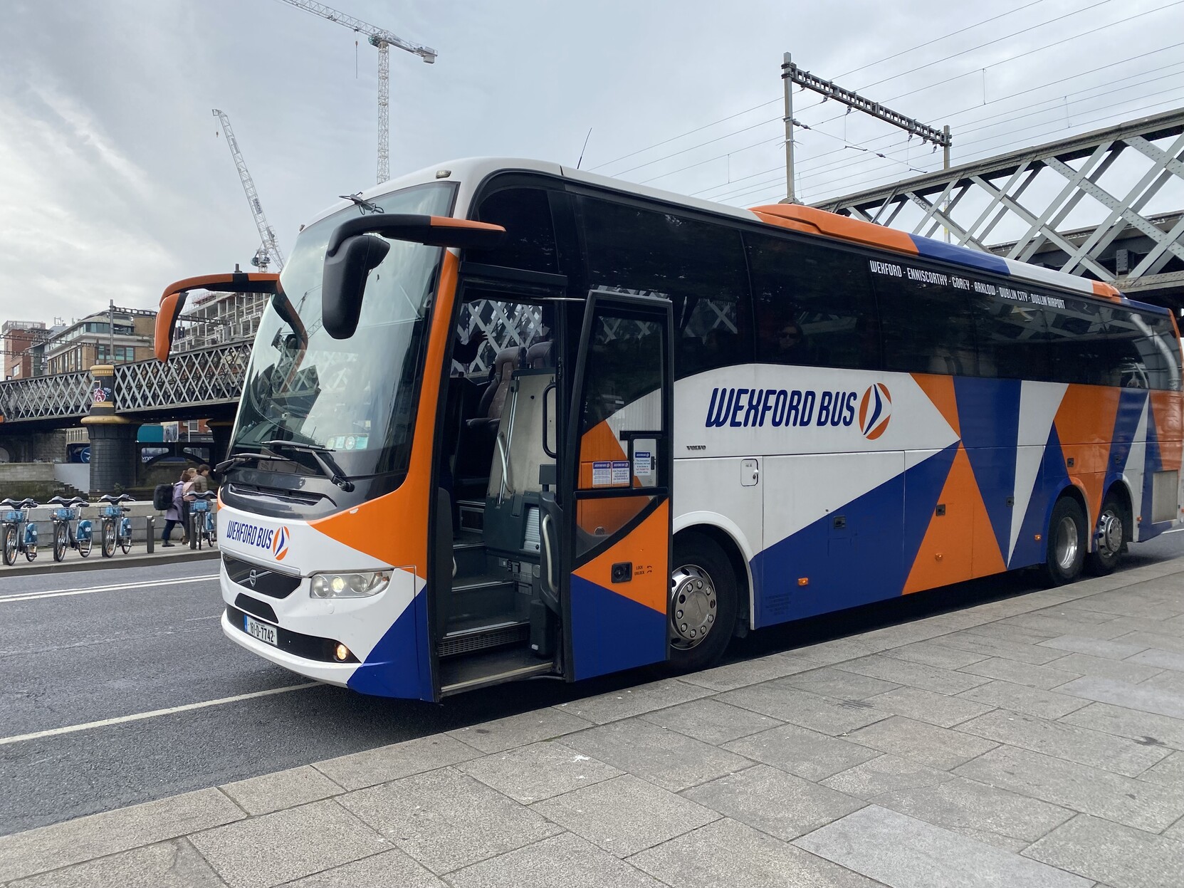 Wexford Bus coach on Custom House Quay with railway bridge in background