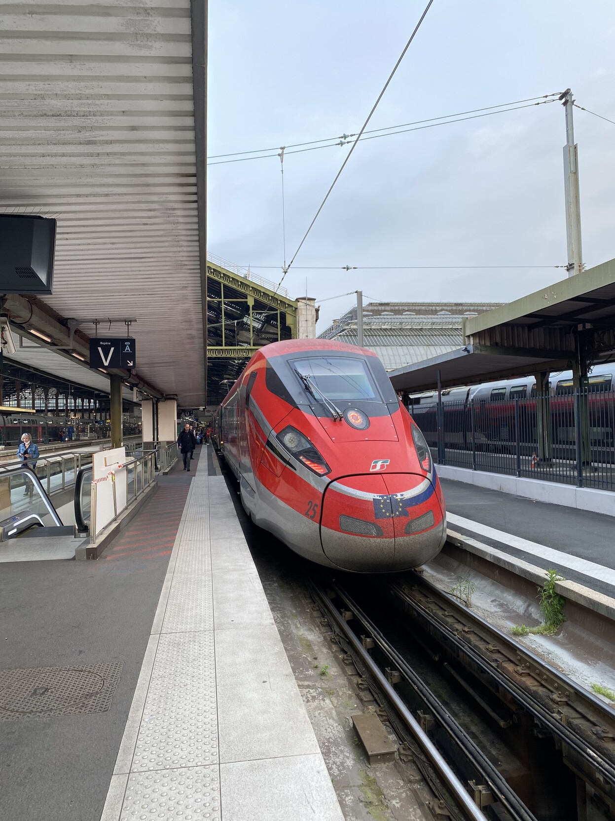 Red high speed Frecciarossa train viewed from the front on the platform in Paris