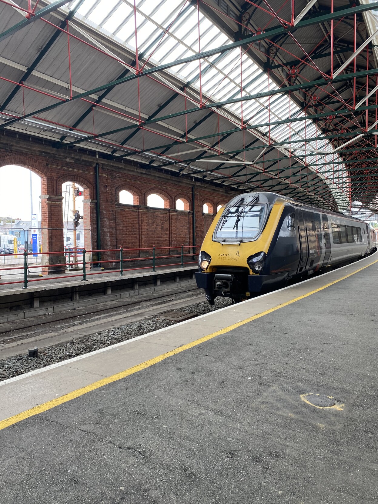 Avanti West Coast train arriving into Holyhead. Front view of train under light steel and glass railway shed