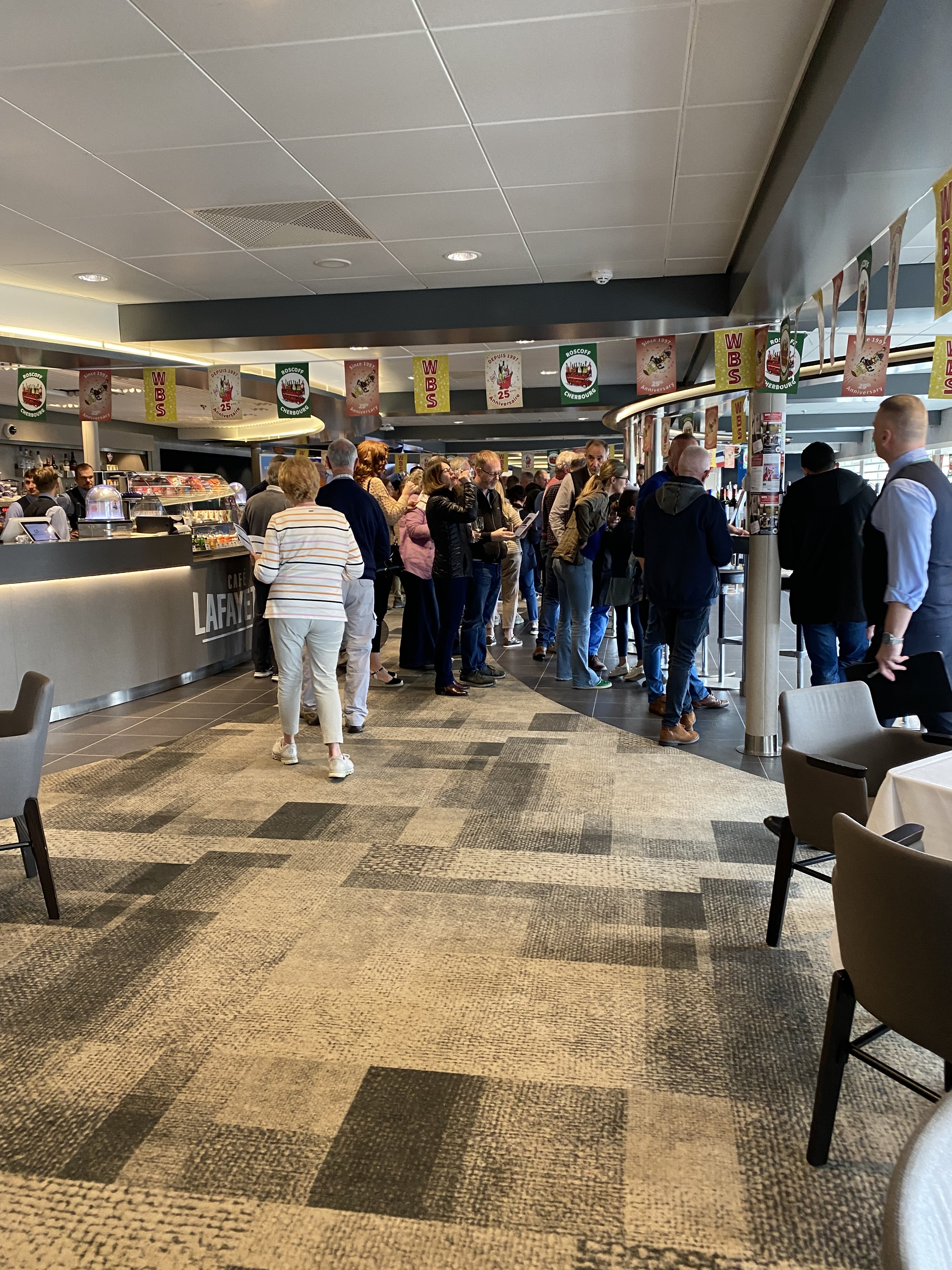 A bar scene with people attending a wine tasting.